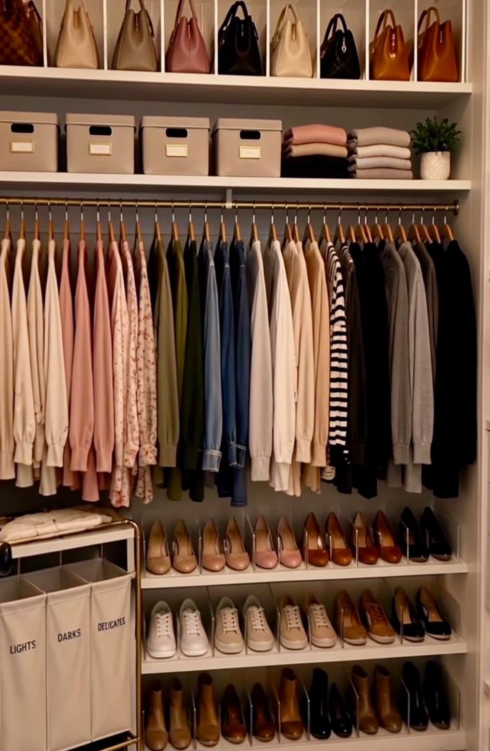 Closet with hanging clothes and shoe rows